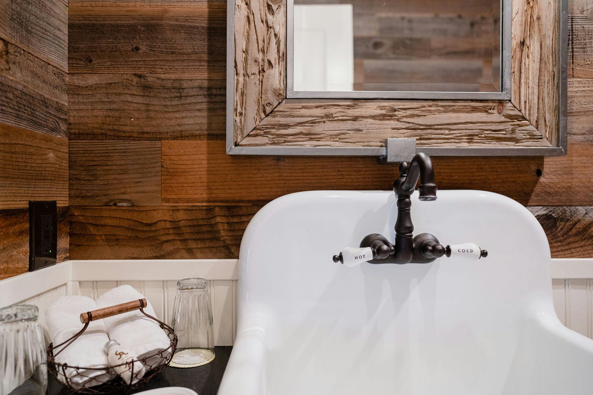 white sink and wooden walls