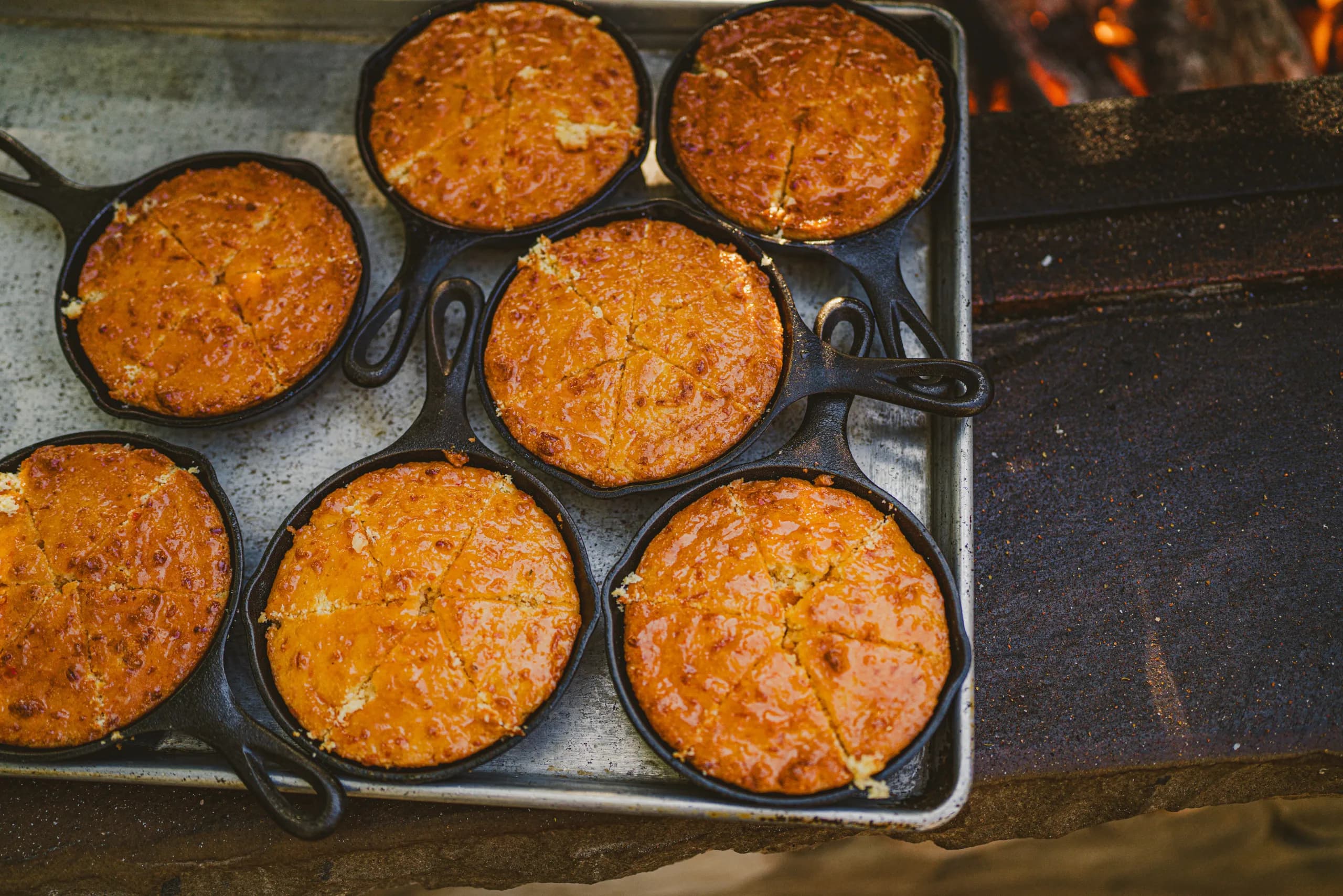 small pies in cast iron pans on a tray