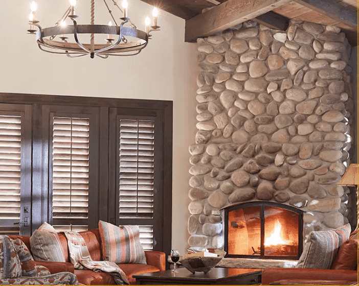 living room area with seating and burning fireplace