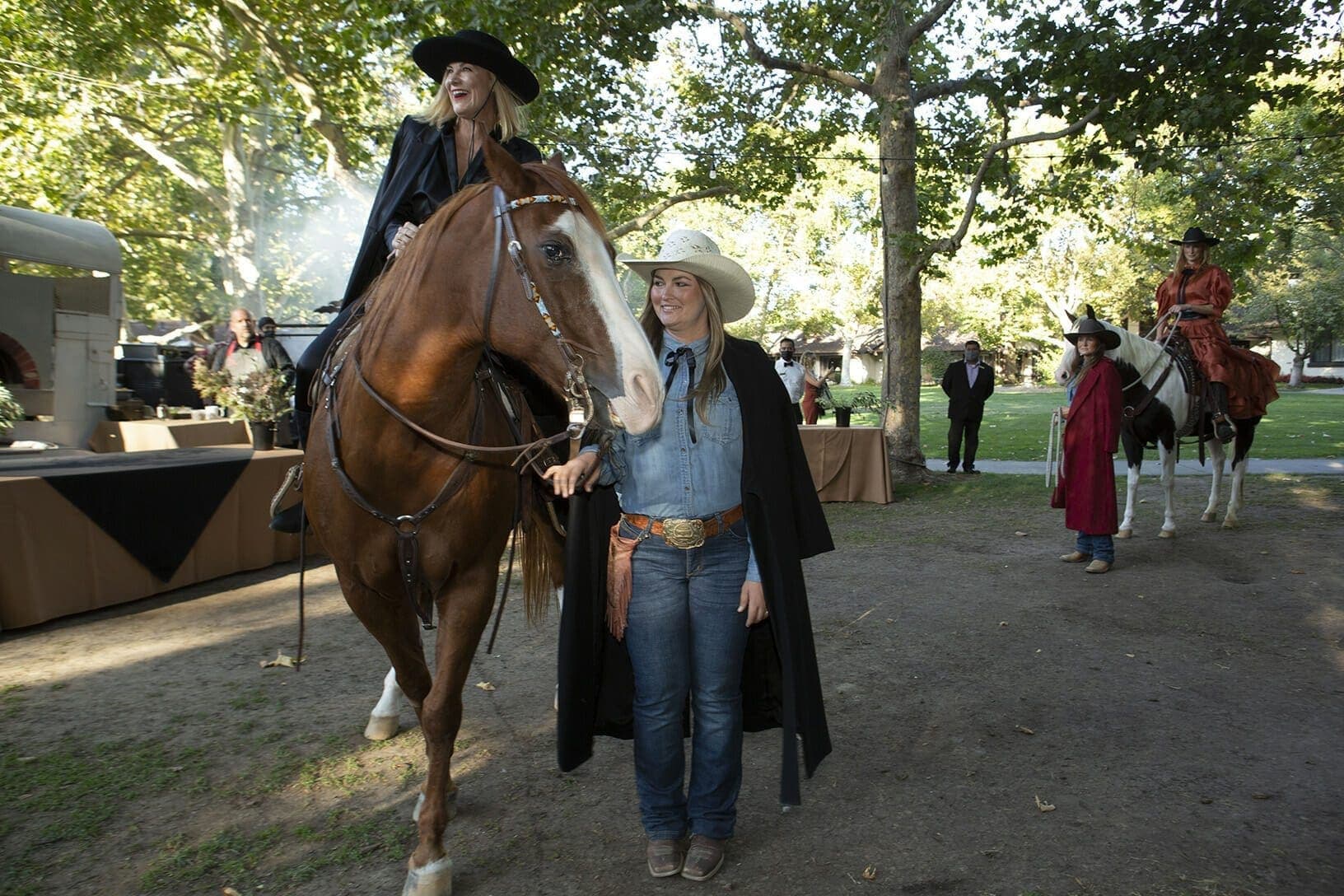 person riding a horse and while someone holds the reigns