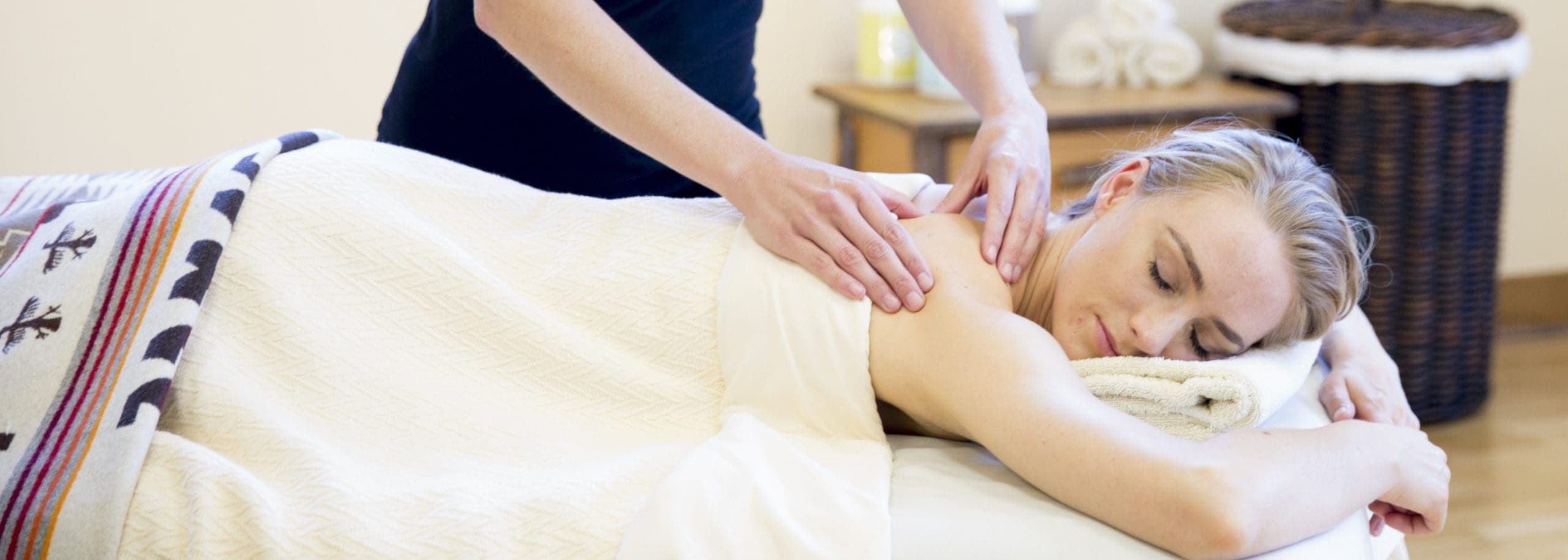 person laying down getting shoulder massage