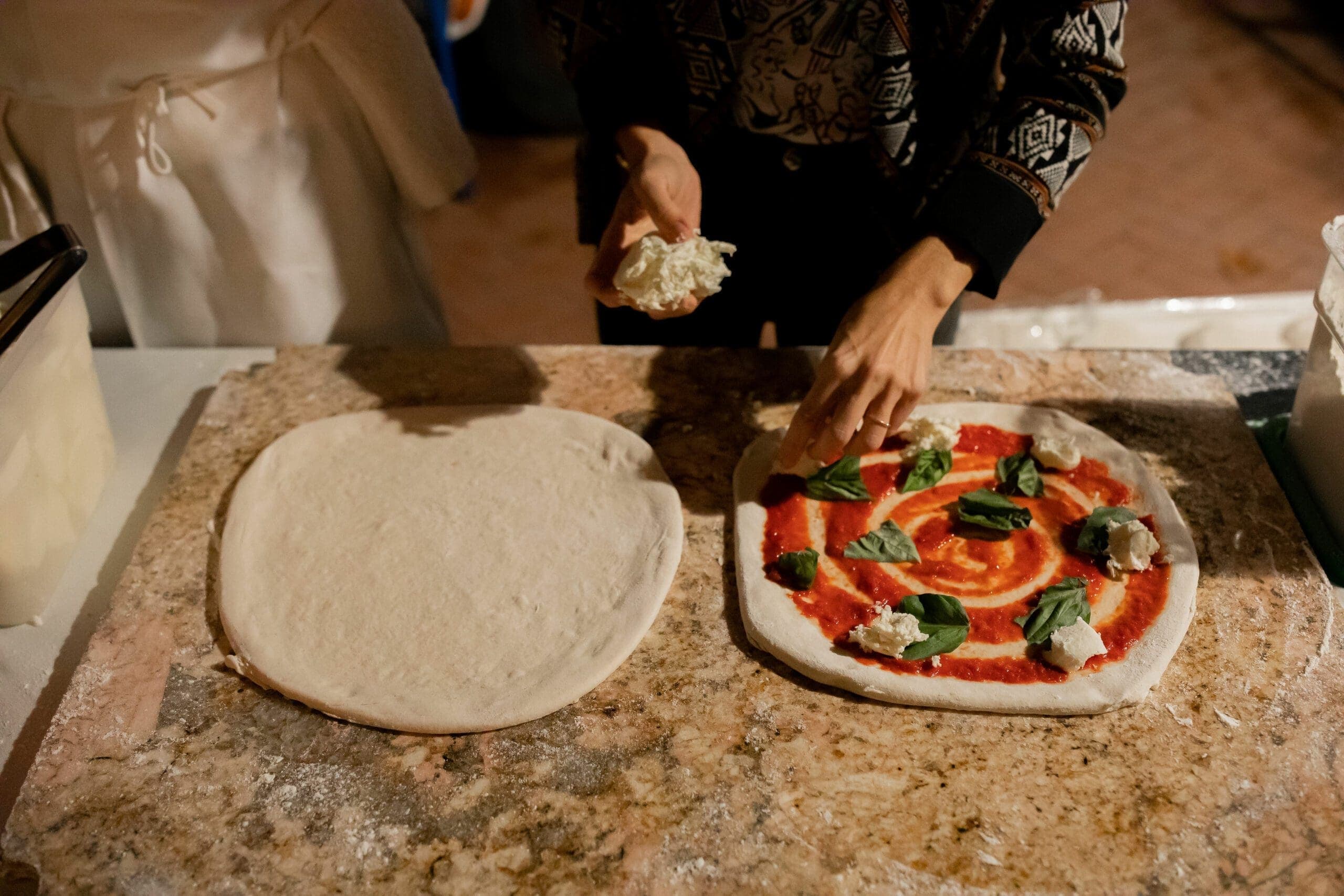person making fresh pizza