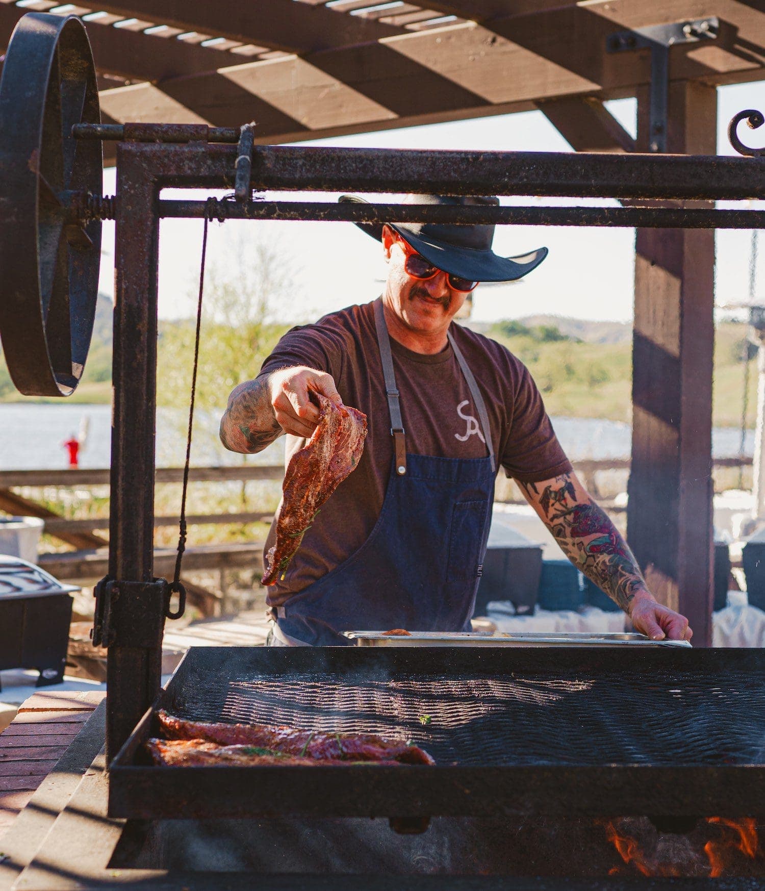 Man cooking steak on a bbq at Alisal Ranch