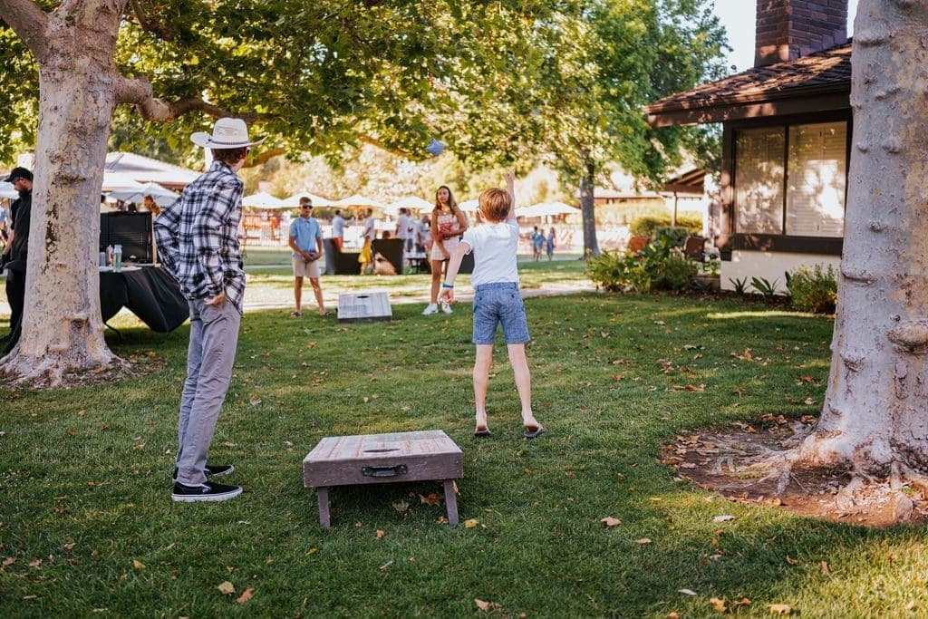 people playing cornhole