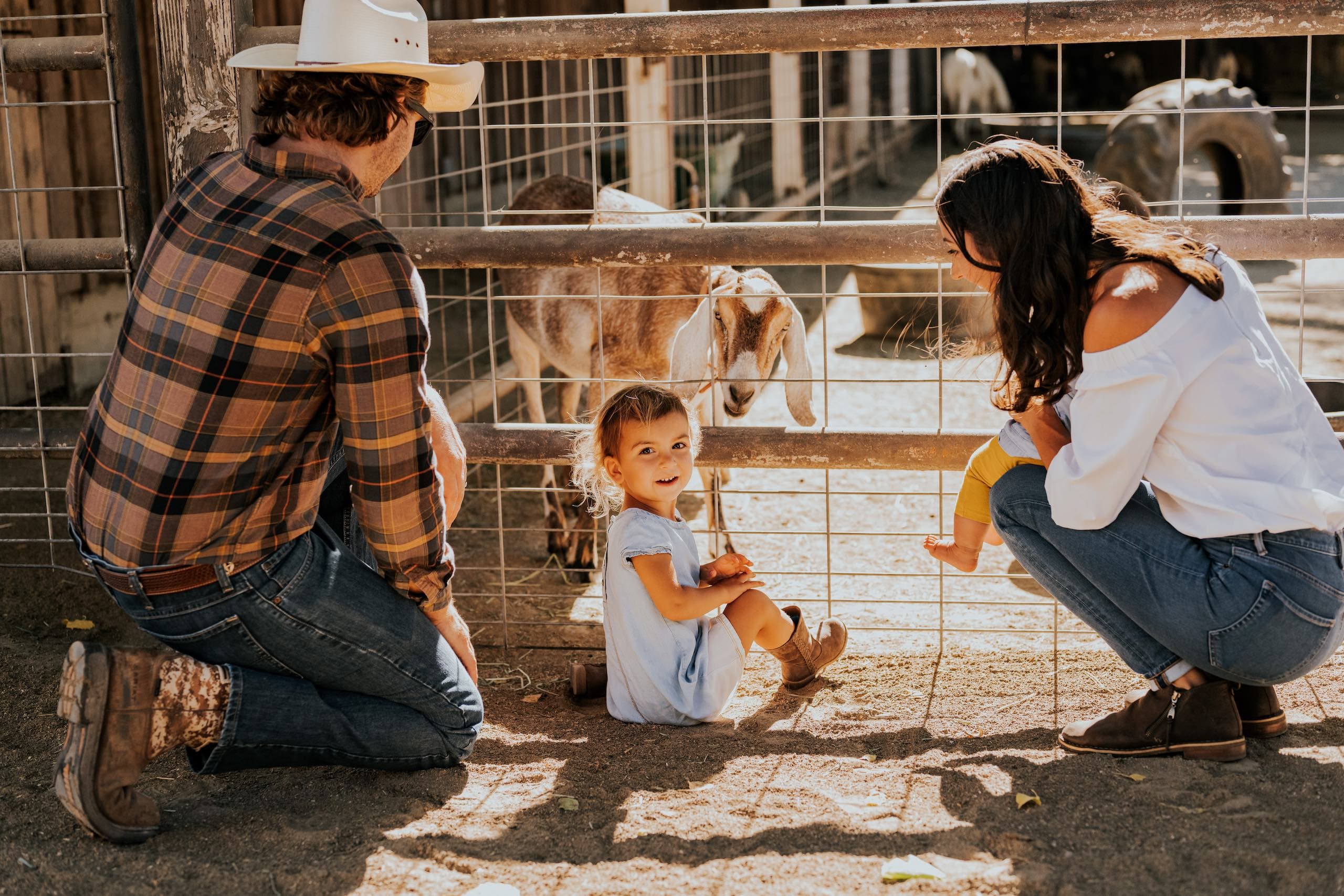 Family in front of a goat enclosure at Alisal Ranch