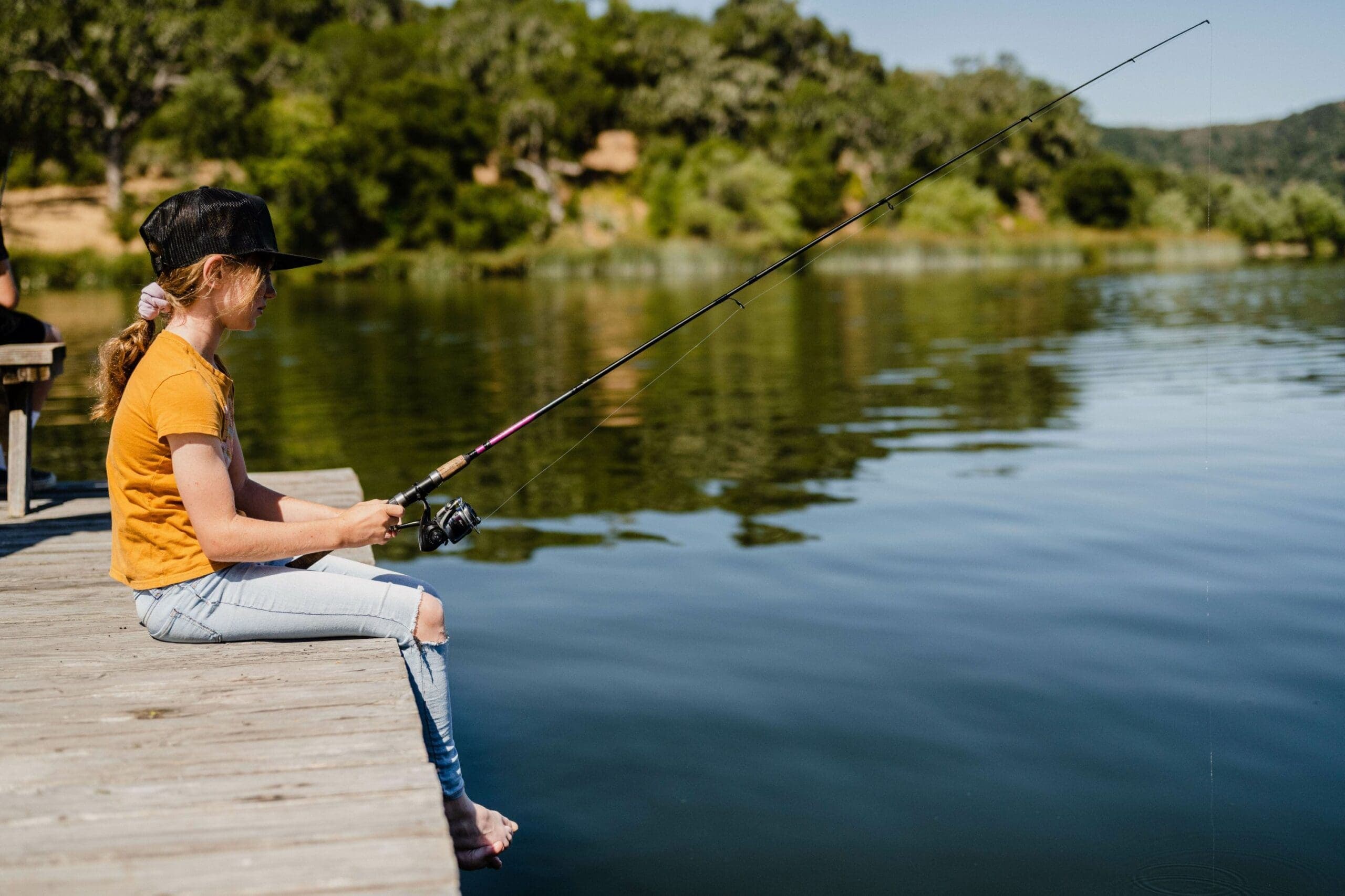 person sitting at the docks fly fishing