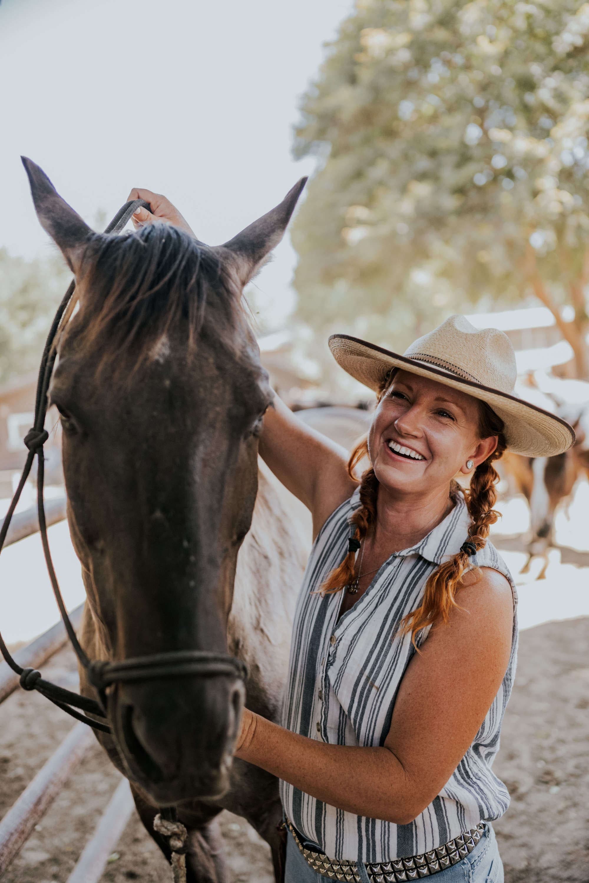 person petting a horse