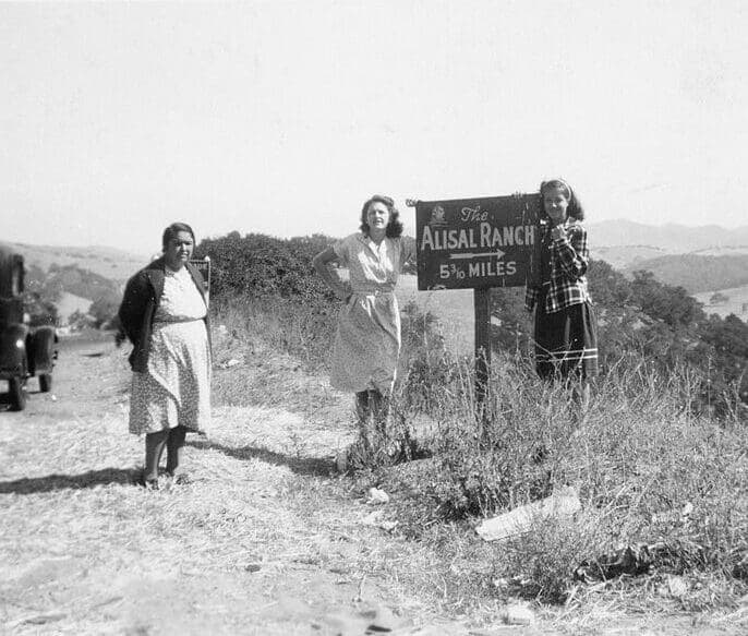 historical photo of people standing by The Alisal Ranch sign