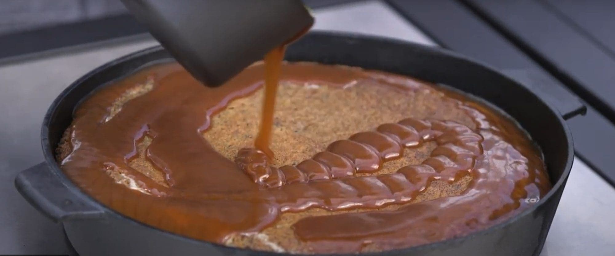 pouring melted toffee onto Mezcal sticky toffee pudding