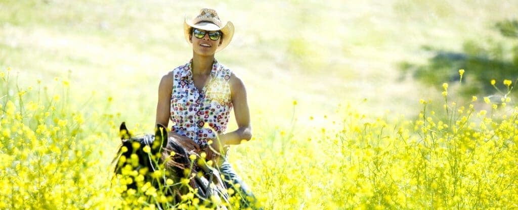Woman on a horse in field of flowers