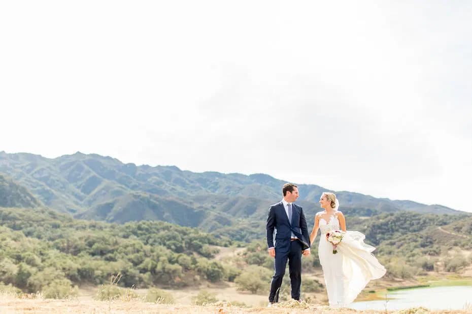 Husband and wife posing front of landscape at Alisal Ranch