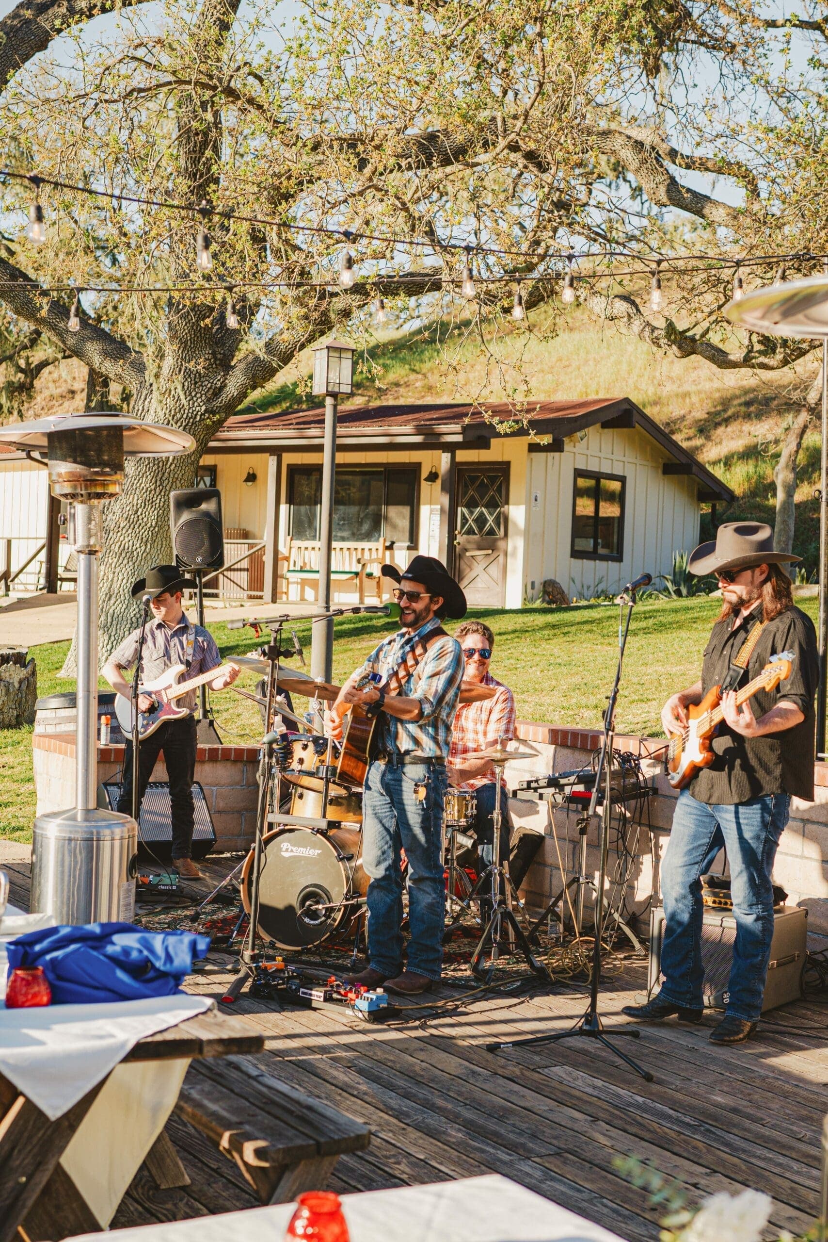 a band playing guitars and drums outdoors