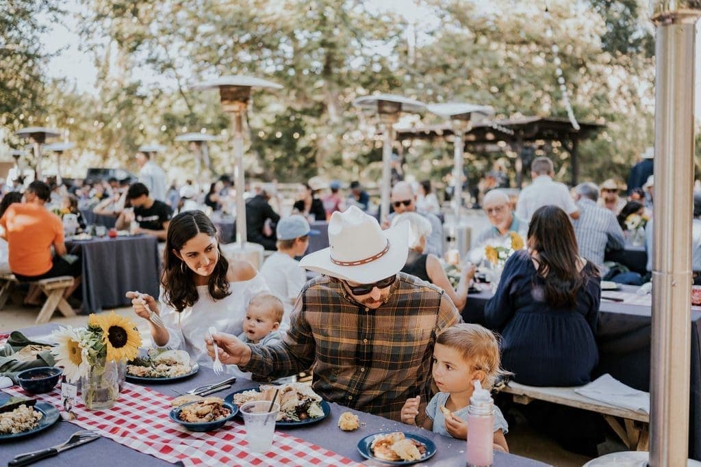 a family sitting at a table eating food