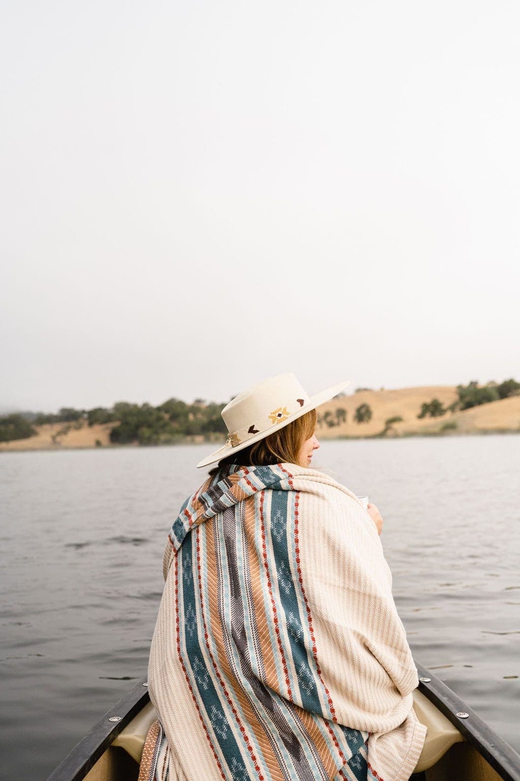 person under blanket on a small boat