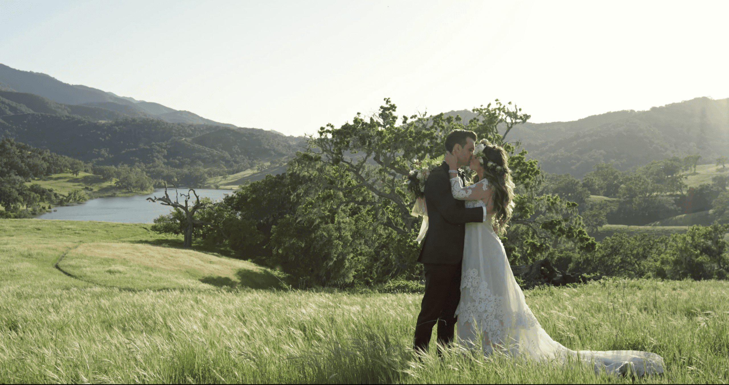 wedding couple kissing on a grass field