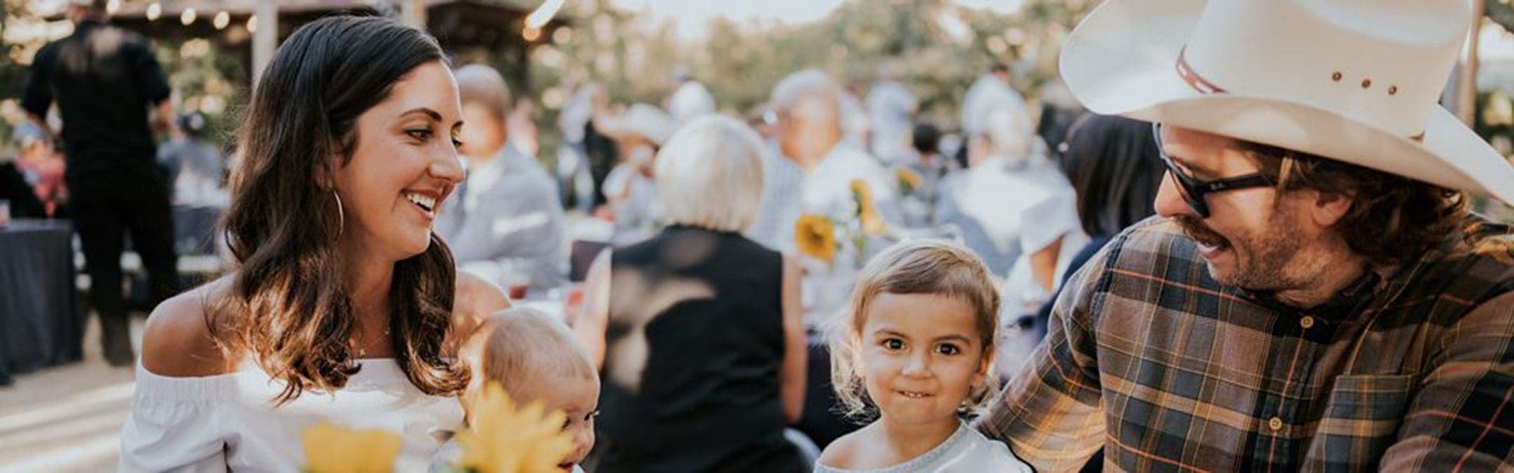 family sitting at a outdoor barbeque