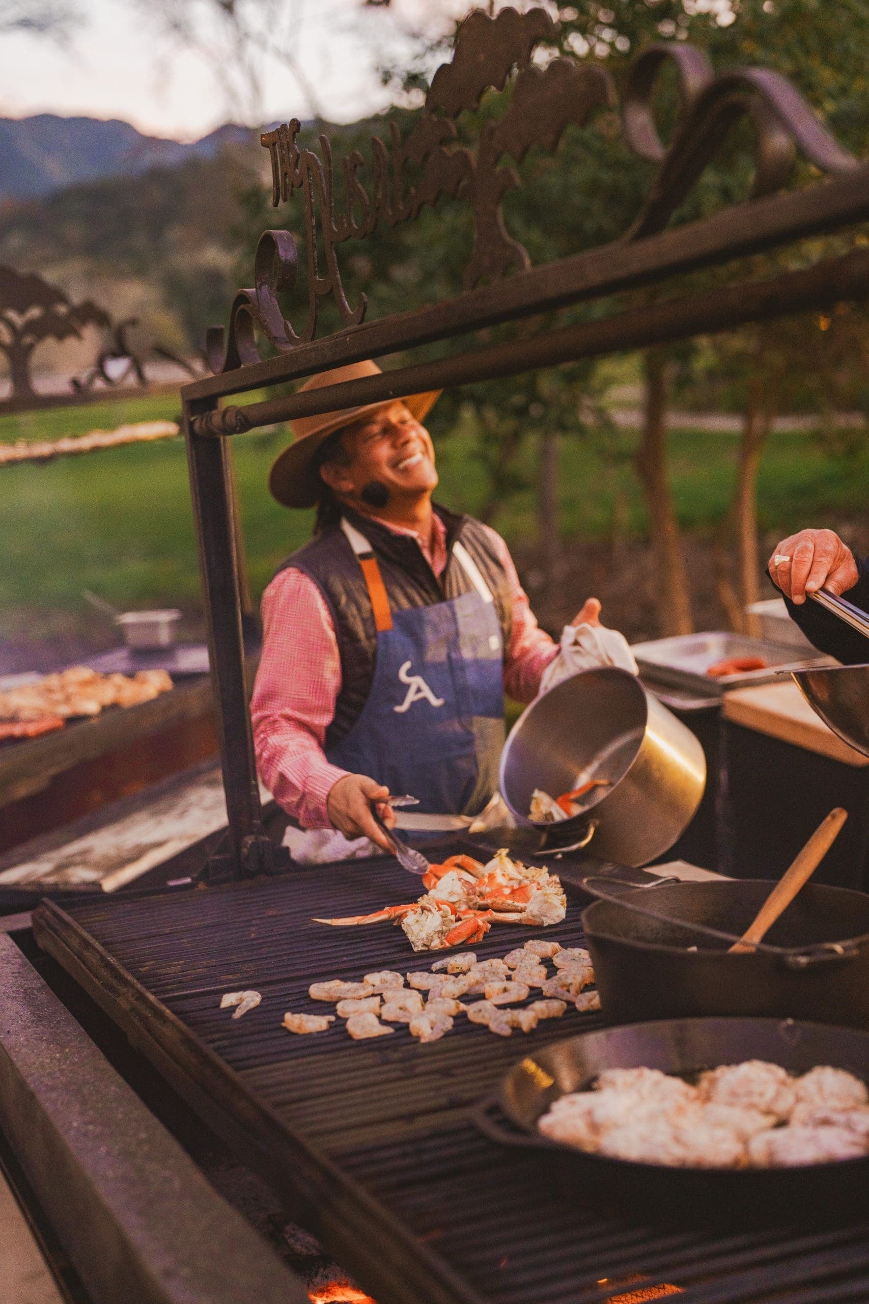 person smiling while barbecuing food