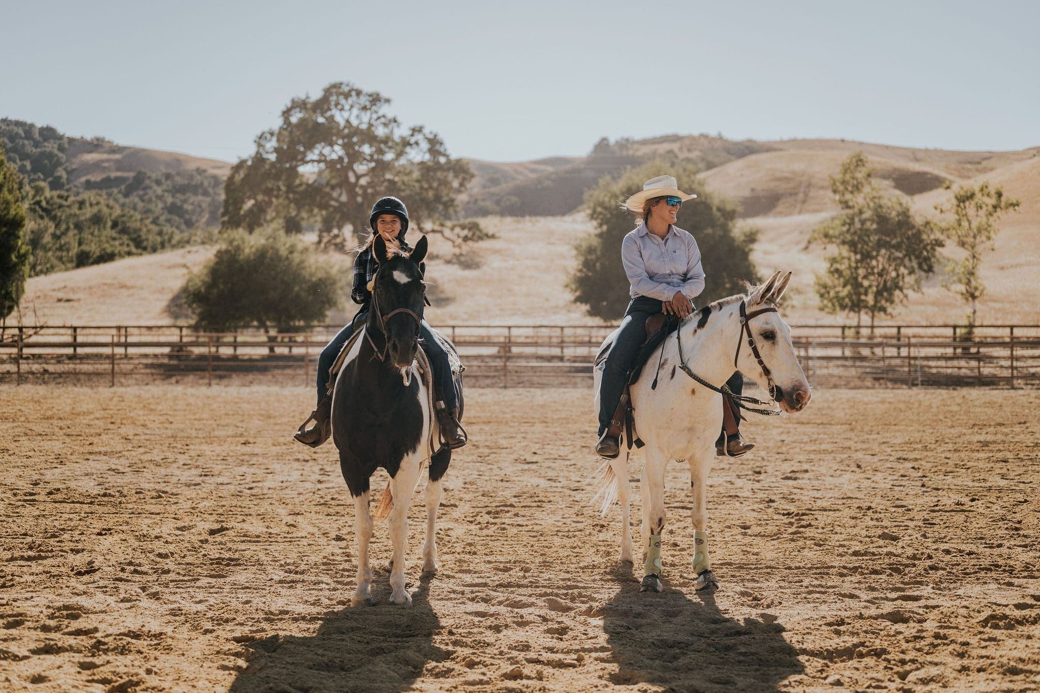 two people riding horses