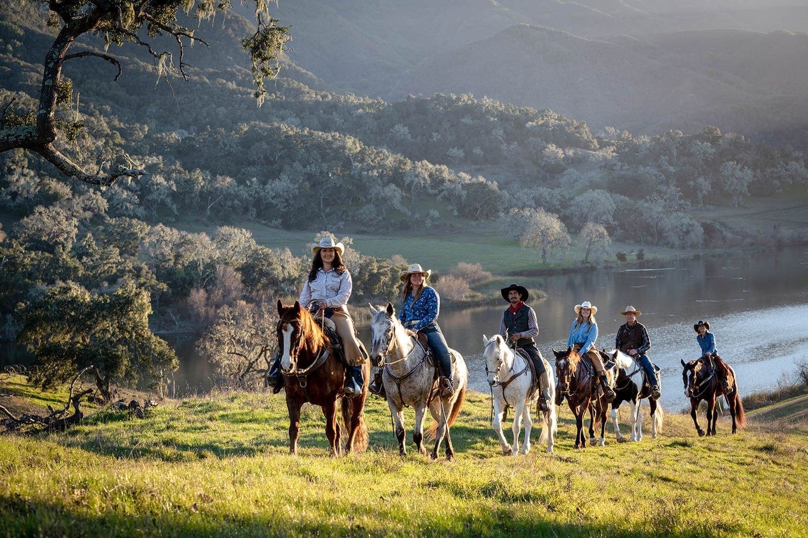 aerial view of landscape and group of people riding horses