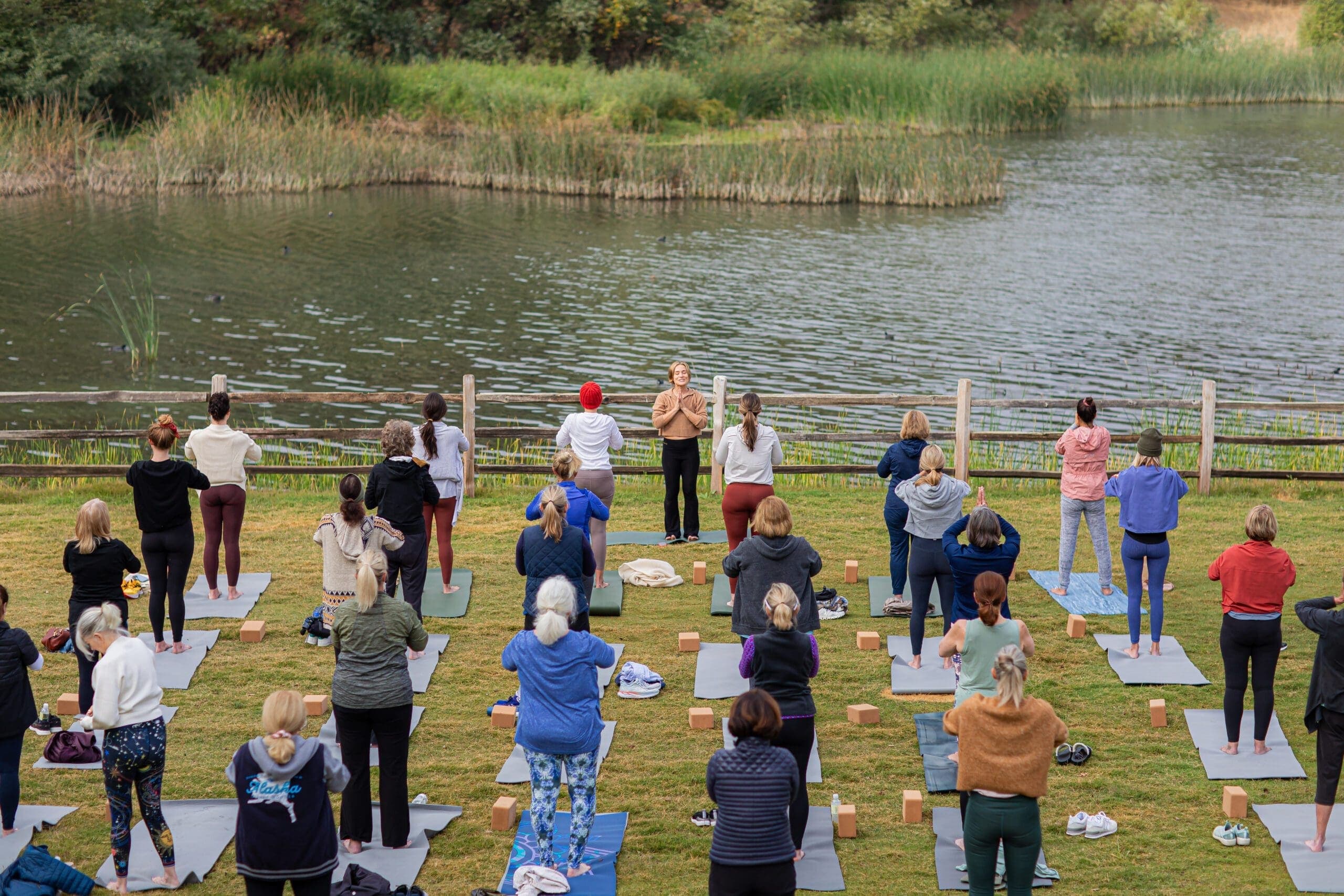 group of people doing outdoor yoga