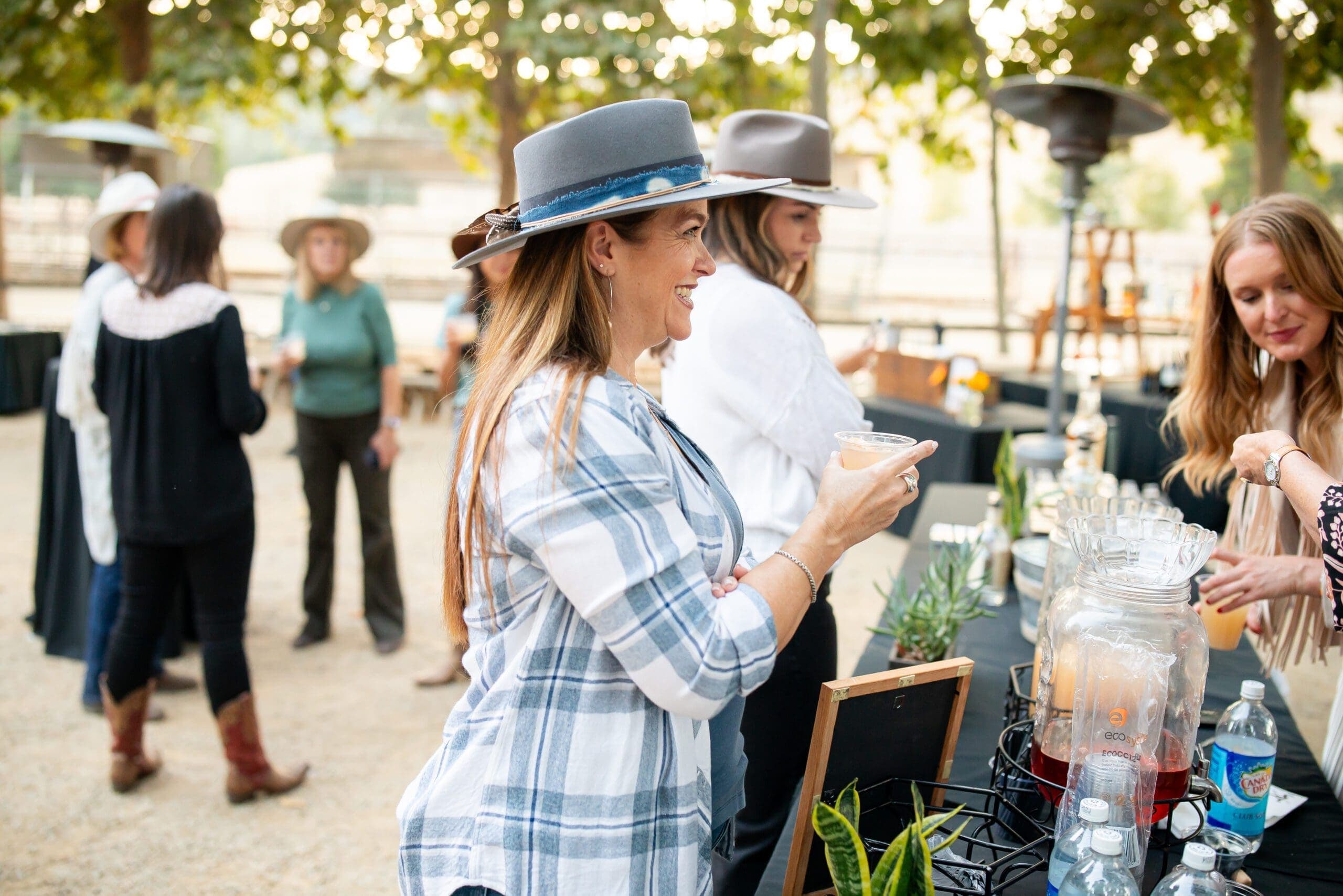 people lining up for drinks at an outdoor bar