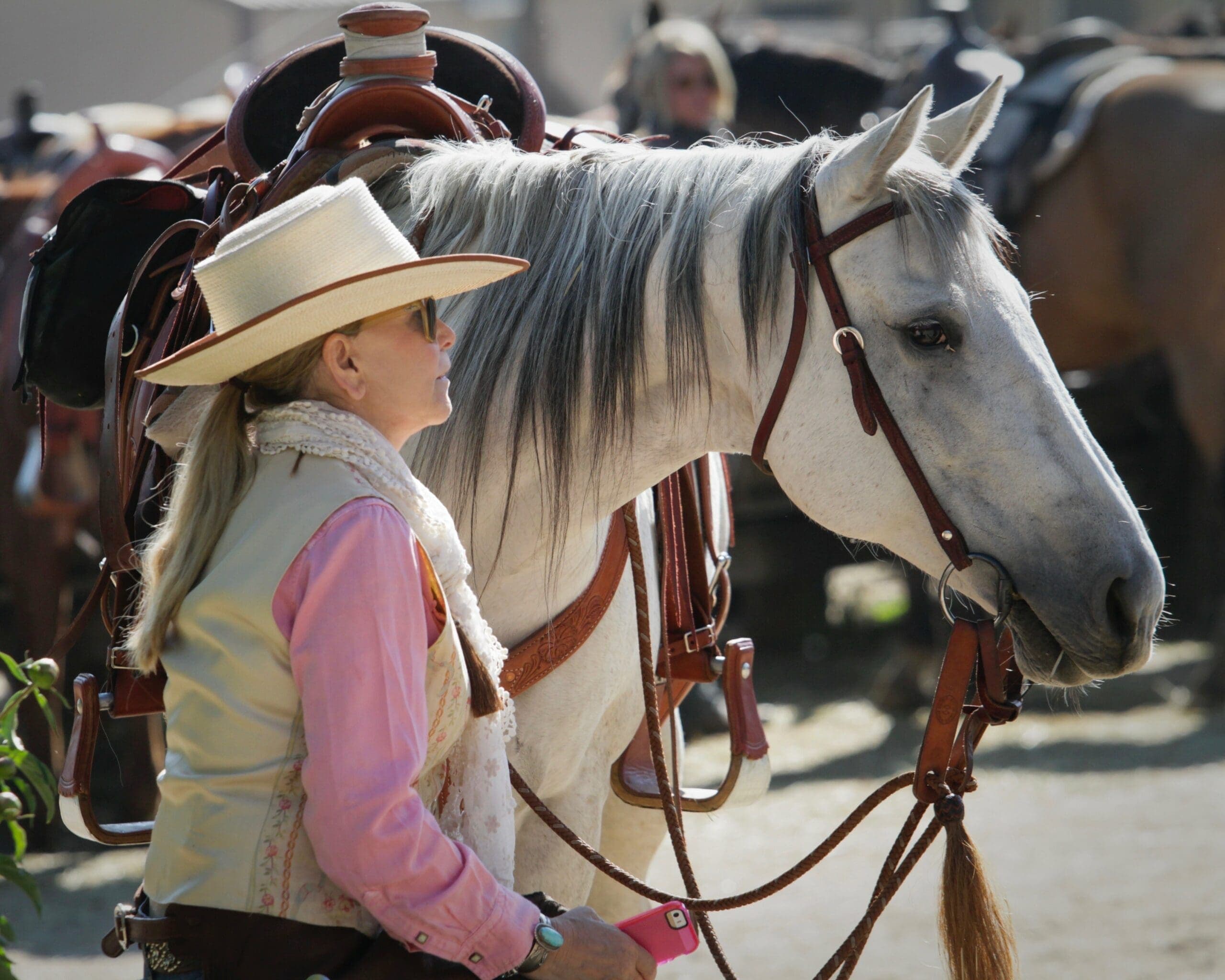 person standing beside horse