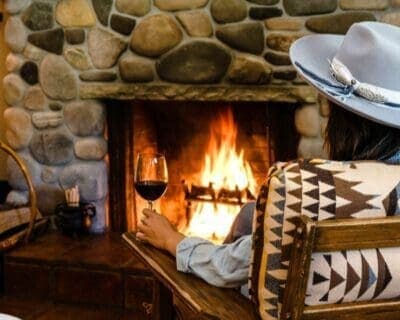 person sitting beside a fireplace