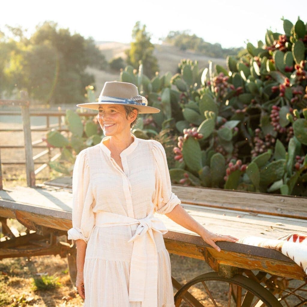 woman smiling beside a wagon