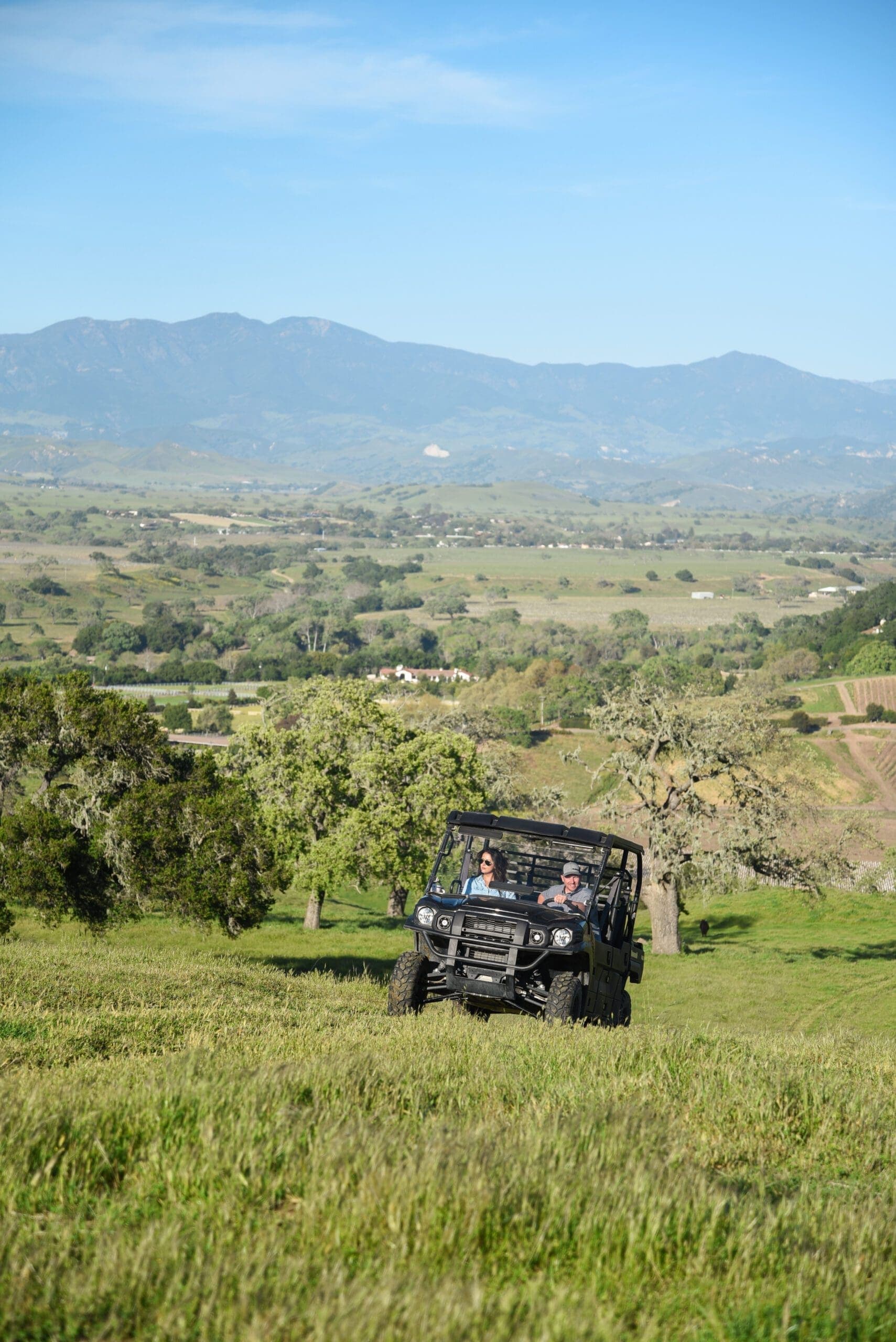 two people in a ATV ride on the ranch