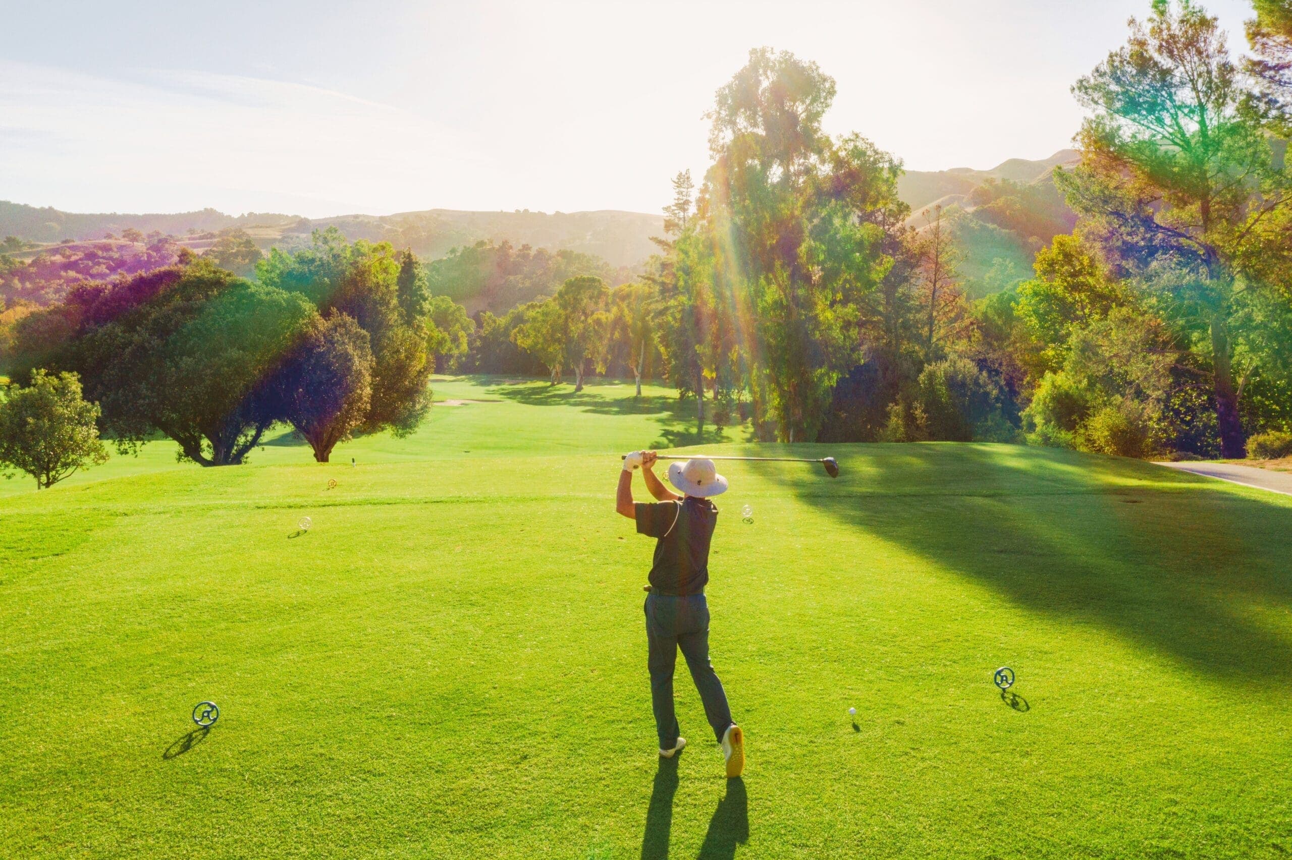 person swinging golf club