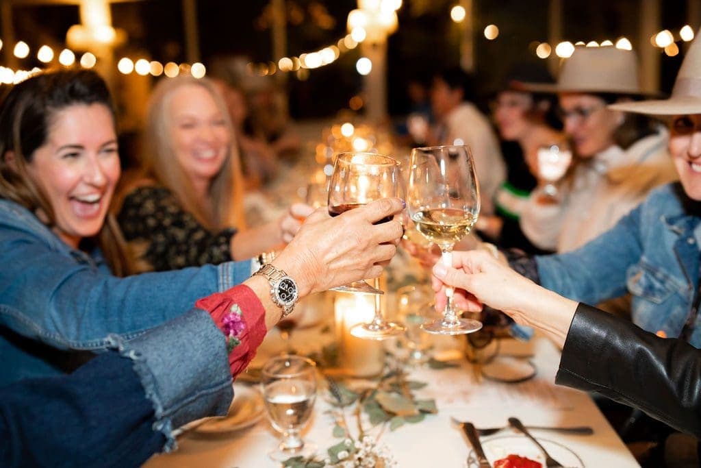 group of people cheering glasses