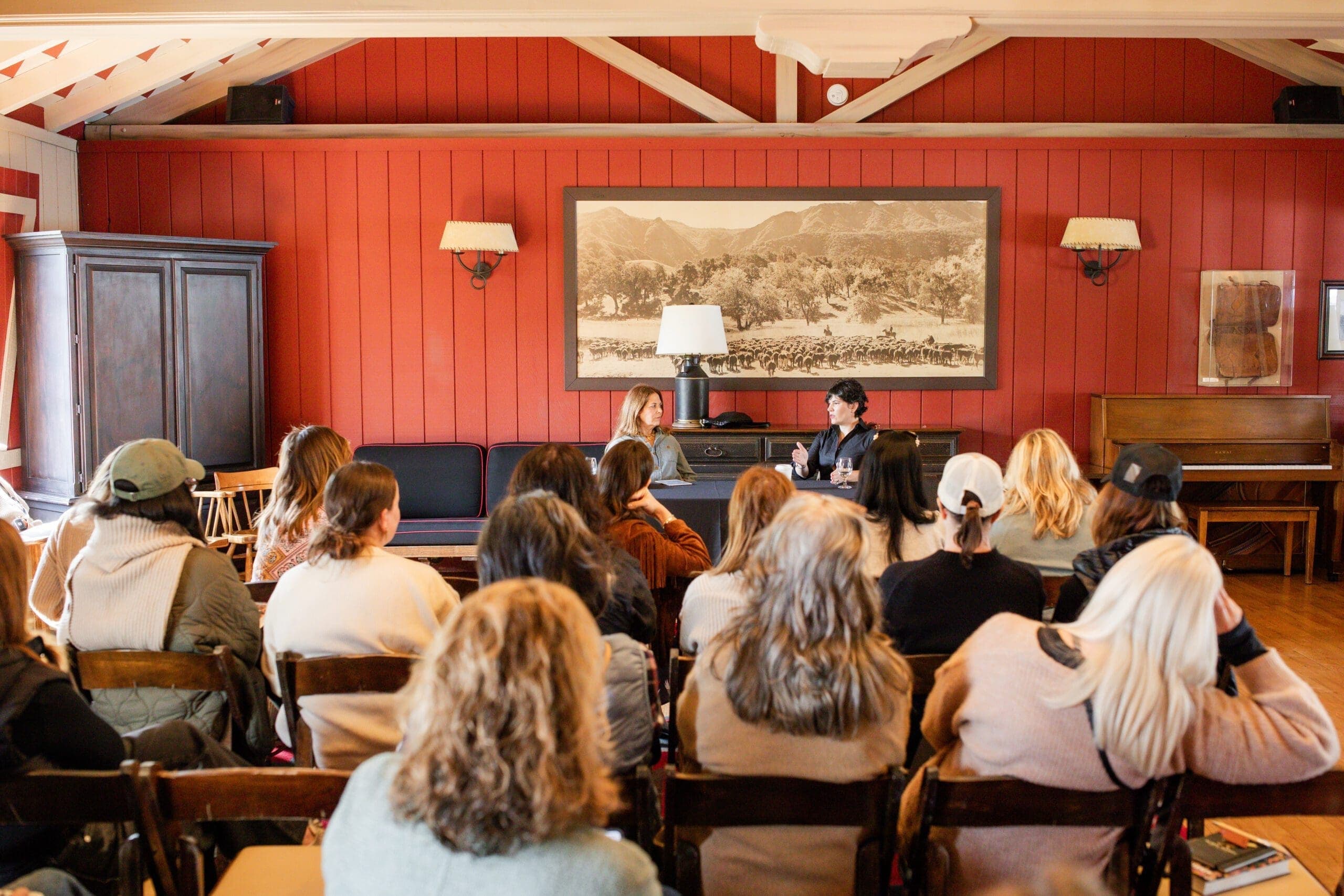 group of people listening to two woman speak