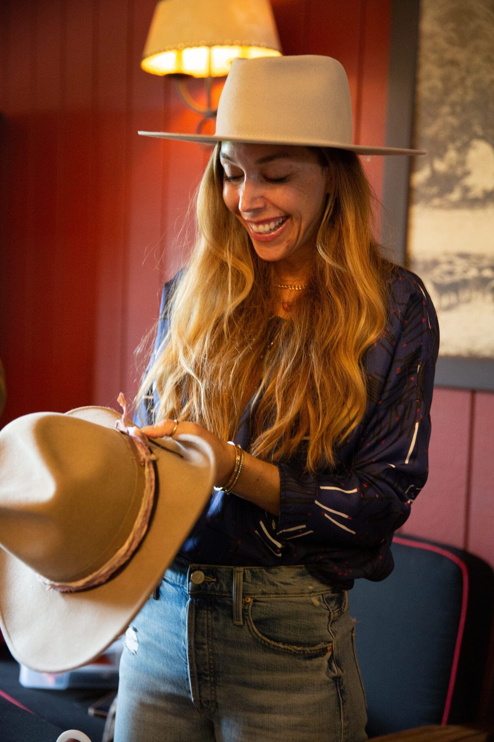 woman holding a cowboy hat