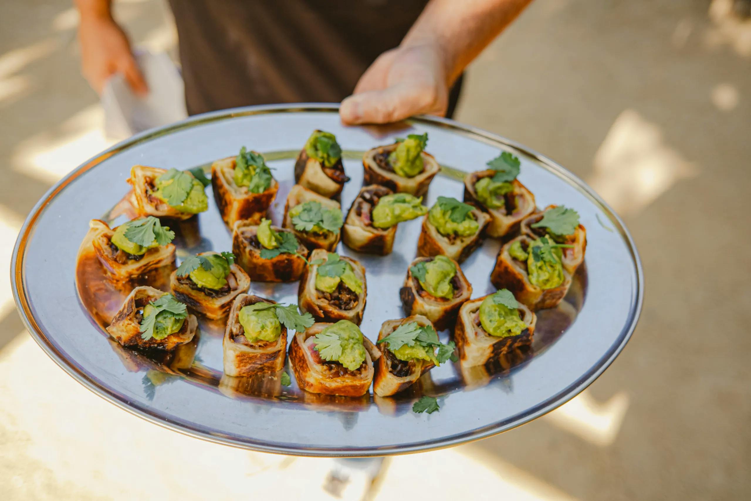 appetizers with guacamole and cilantro on a plate