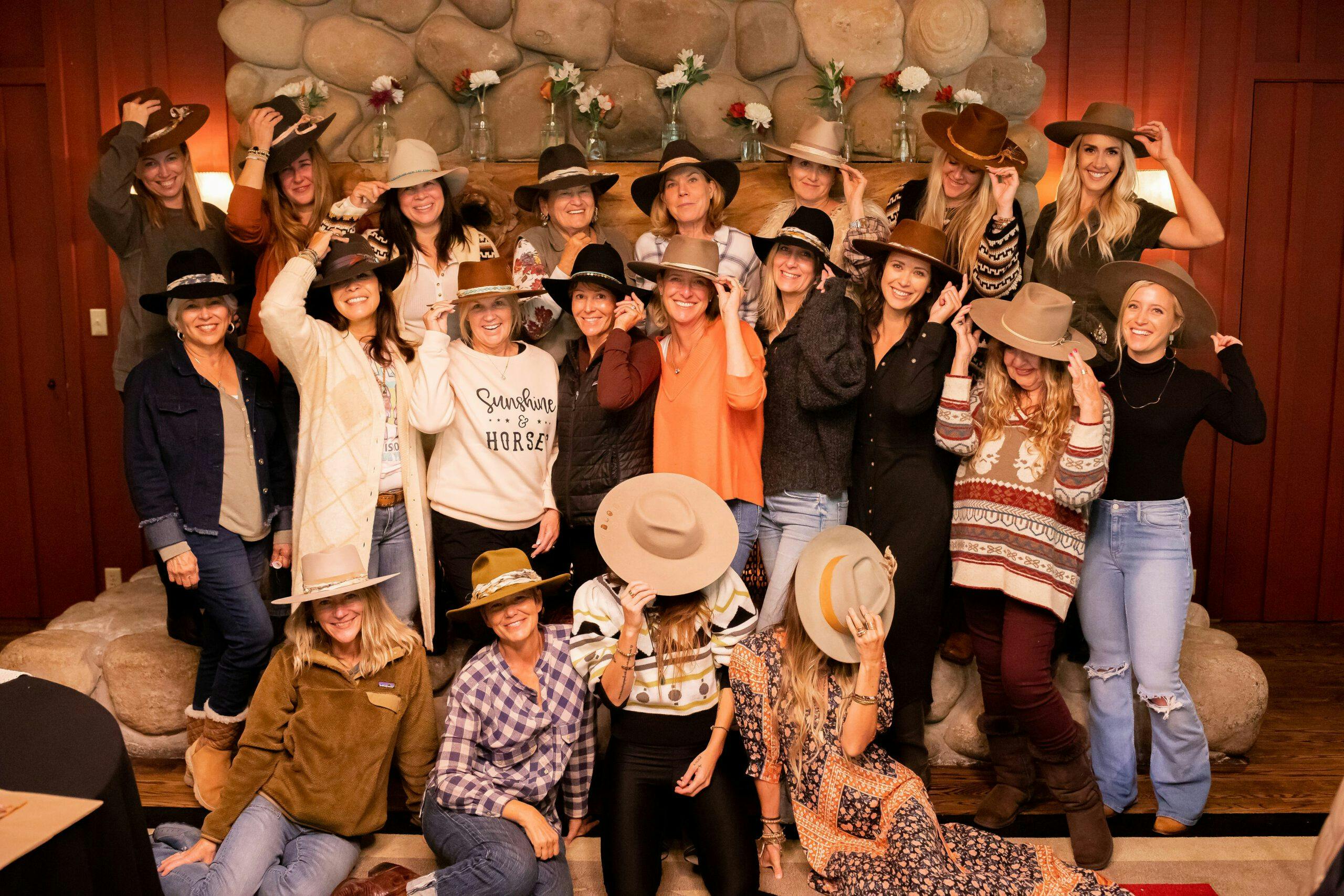 group of people wearing cowboy hats and posing