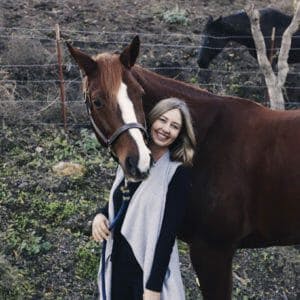 person smiling with horse for camera