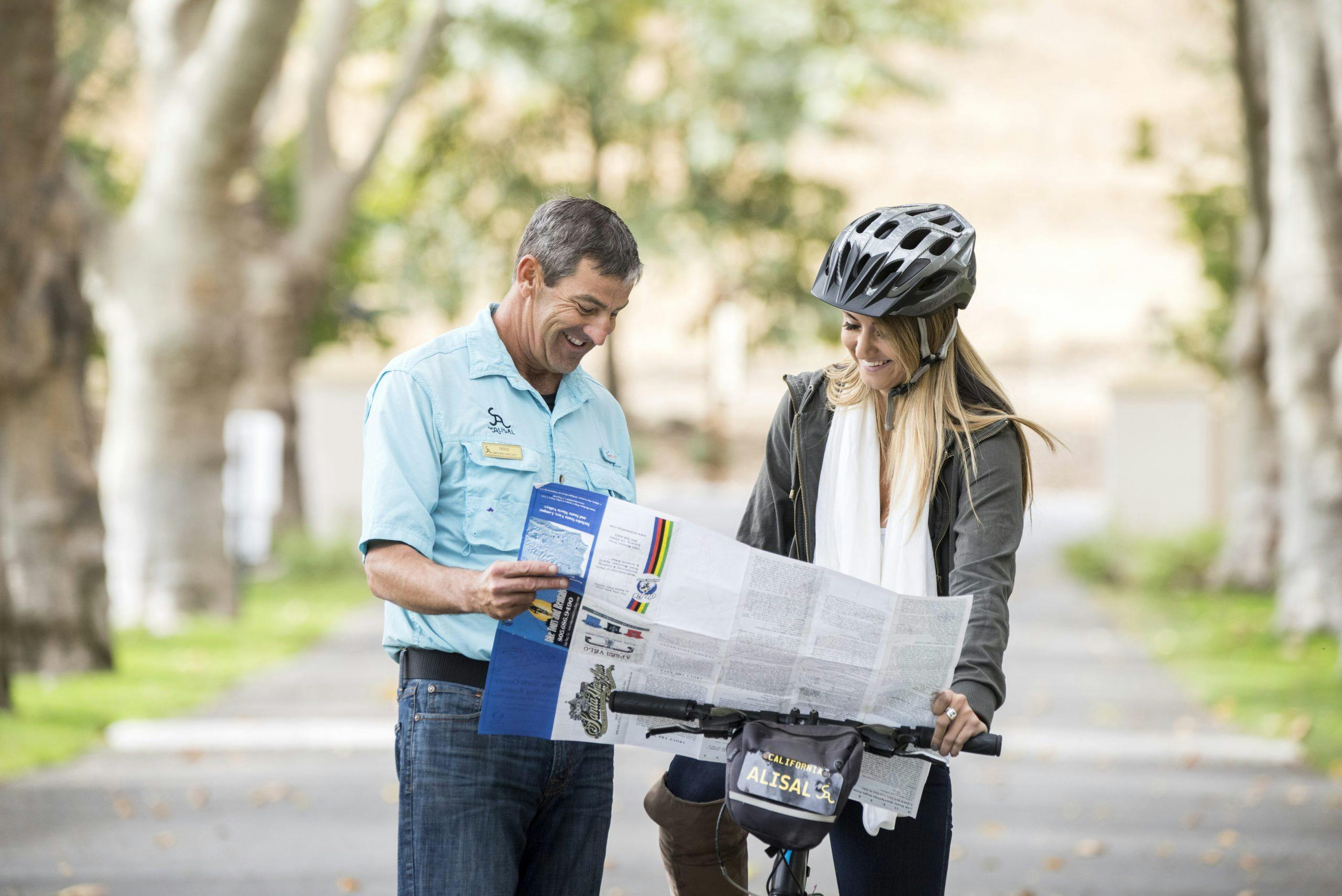 person riding a bicycle getting directions from an Alisal employee