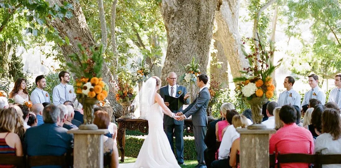 Couple getting married in the sycamore grove at Alisal ranch