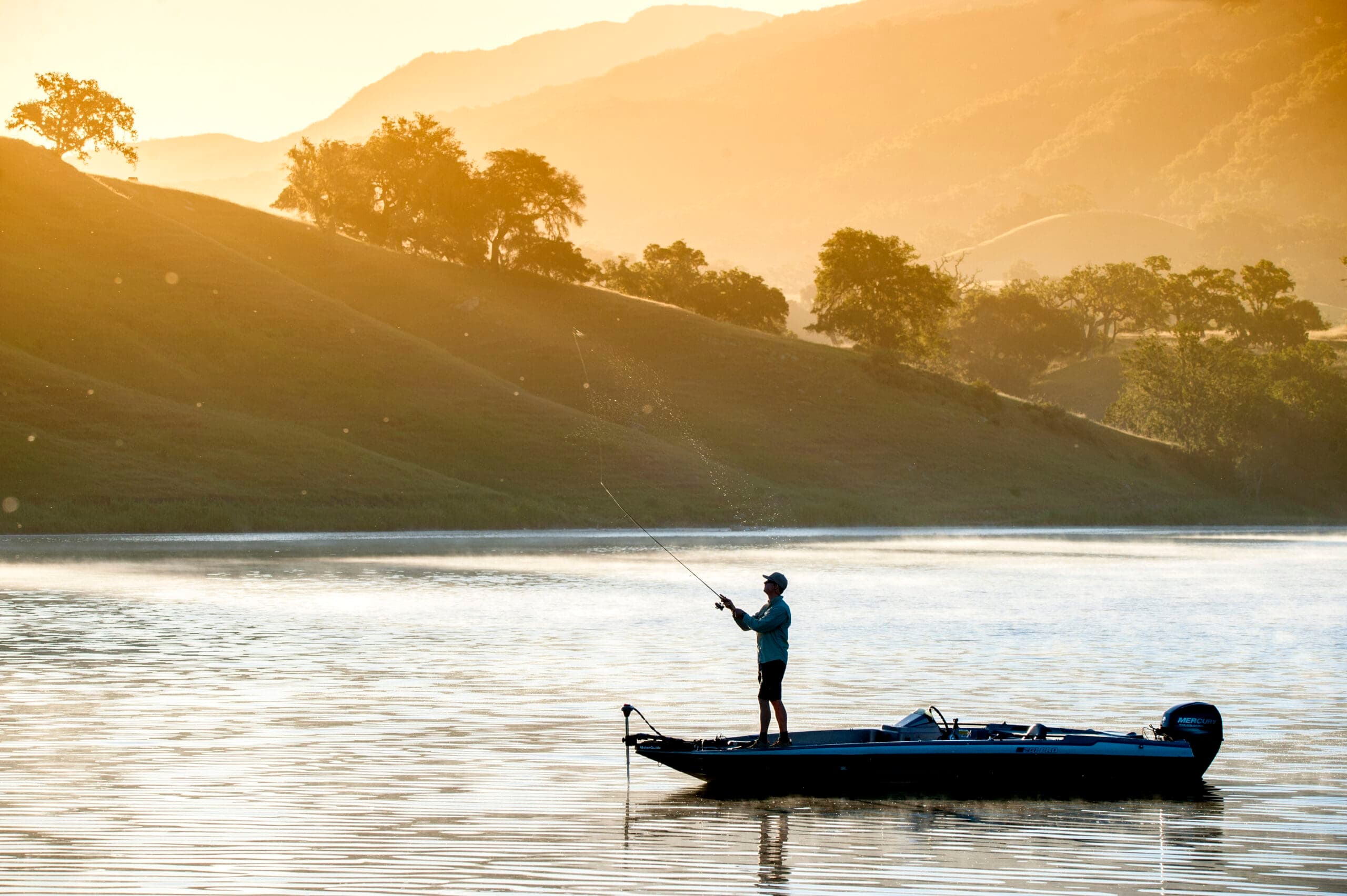 Man enjoying fly fishing on the lake at Alisal Ranch during sunset