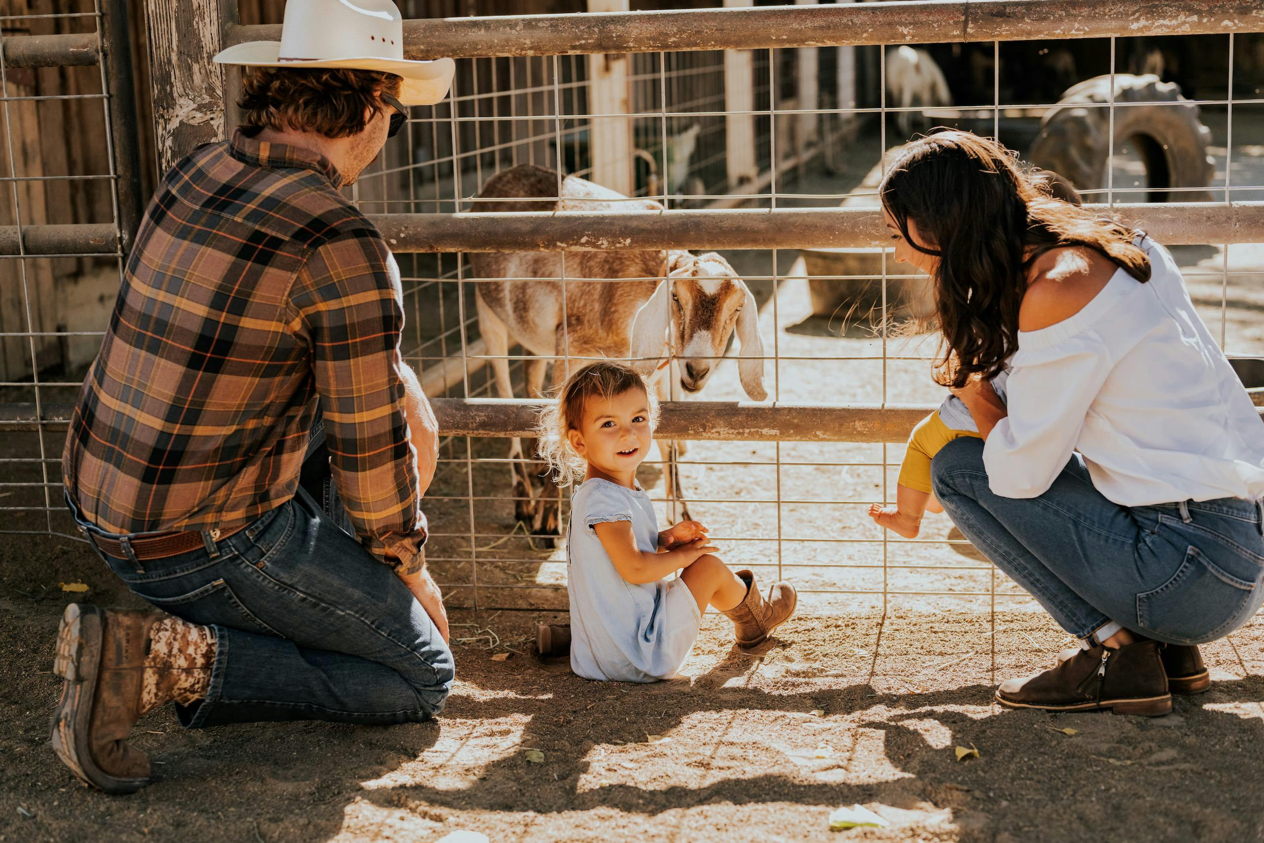 Family in front of a goat enclosure at Alisal Ranch