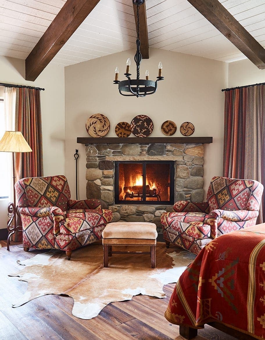 seating area beside burning fireplace inside luxury studio