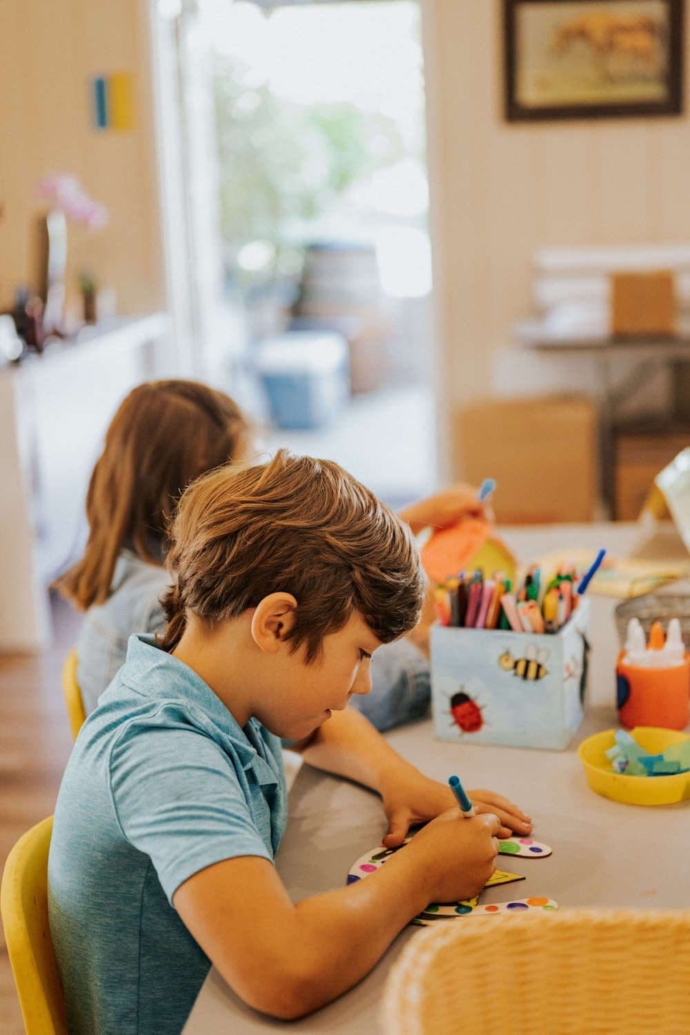 kids doing arts and crafts at a table