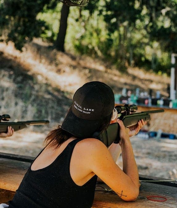 person pointing air rifle at target