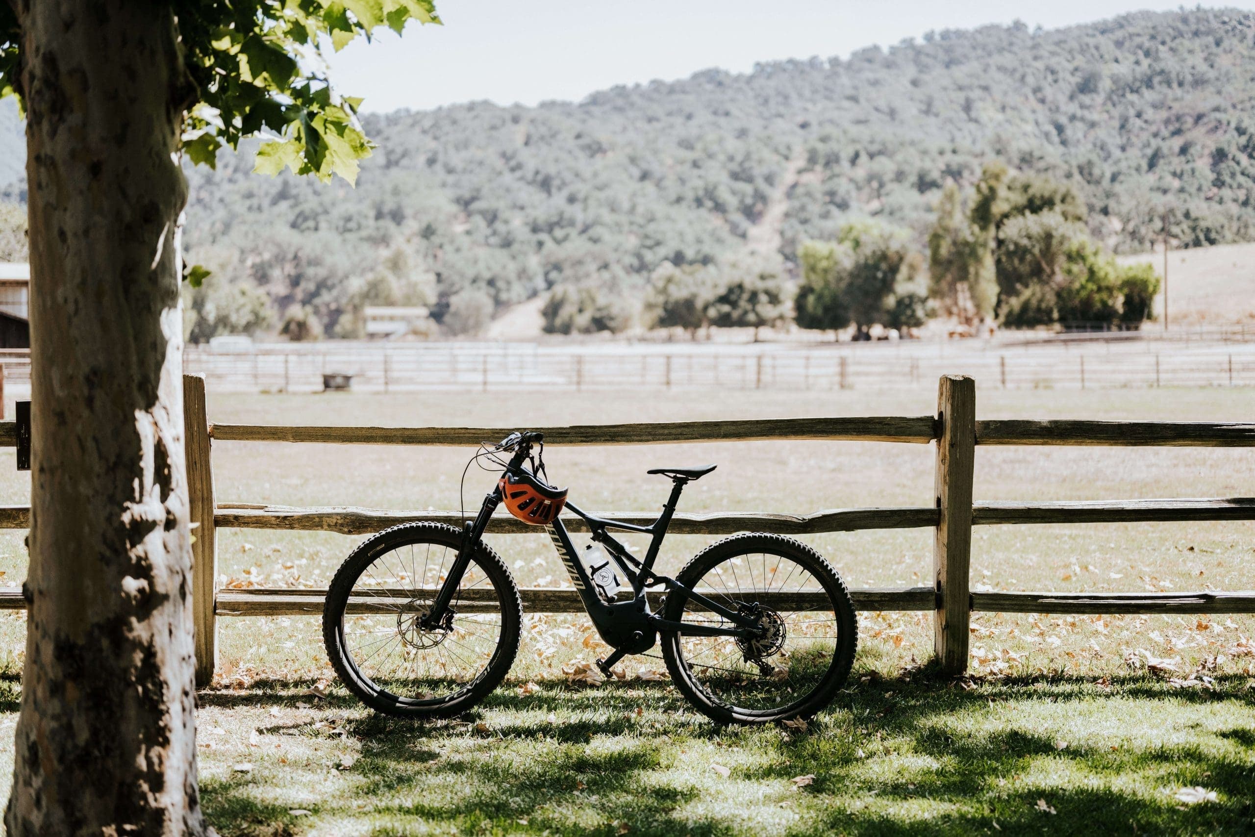 bicycle standing beside a fence
