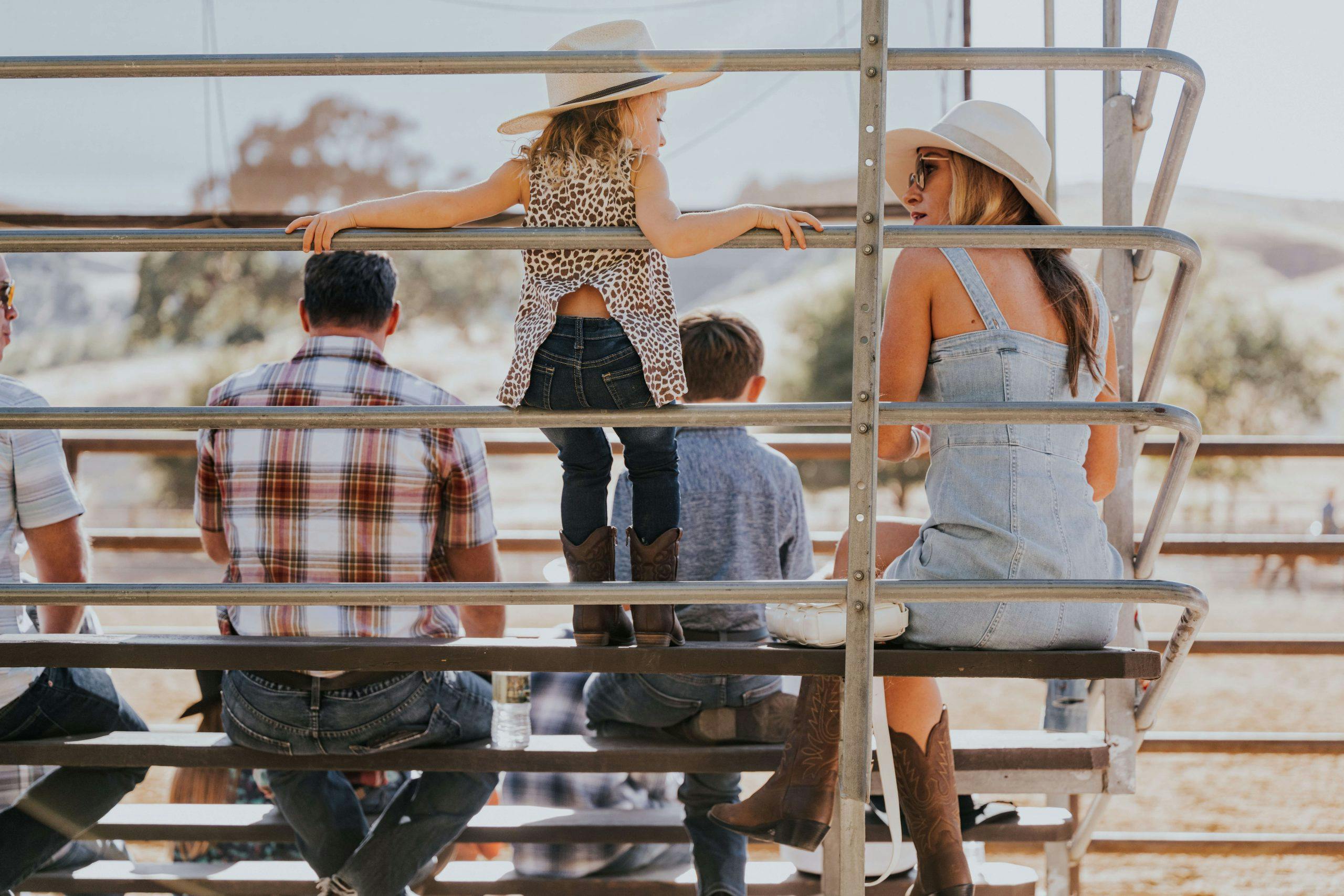 people sitting on the bleachers at the Alisal rodeo