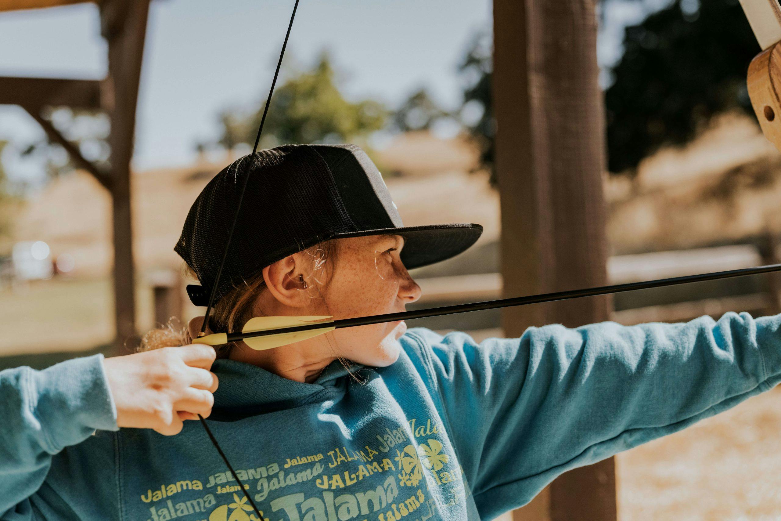 person using a bow and arrow