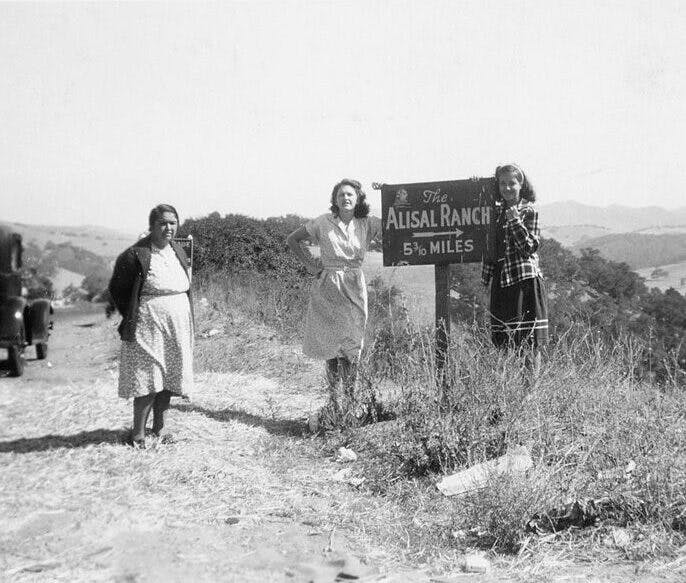 historical photo of people standing by The Alisal Ranch sign