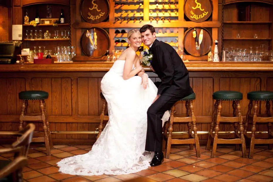 Couple at the Alisal bar in suit and wedding dress