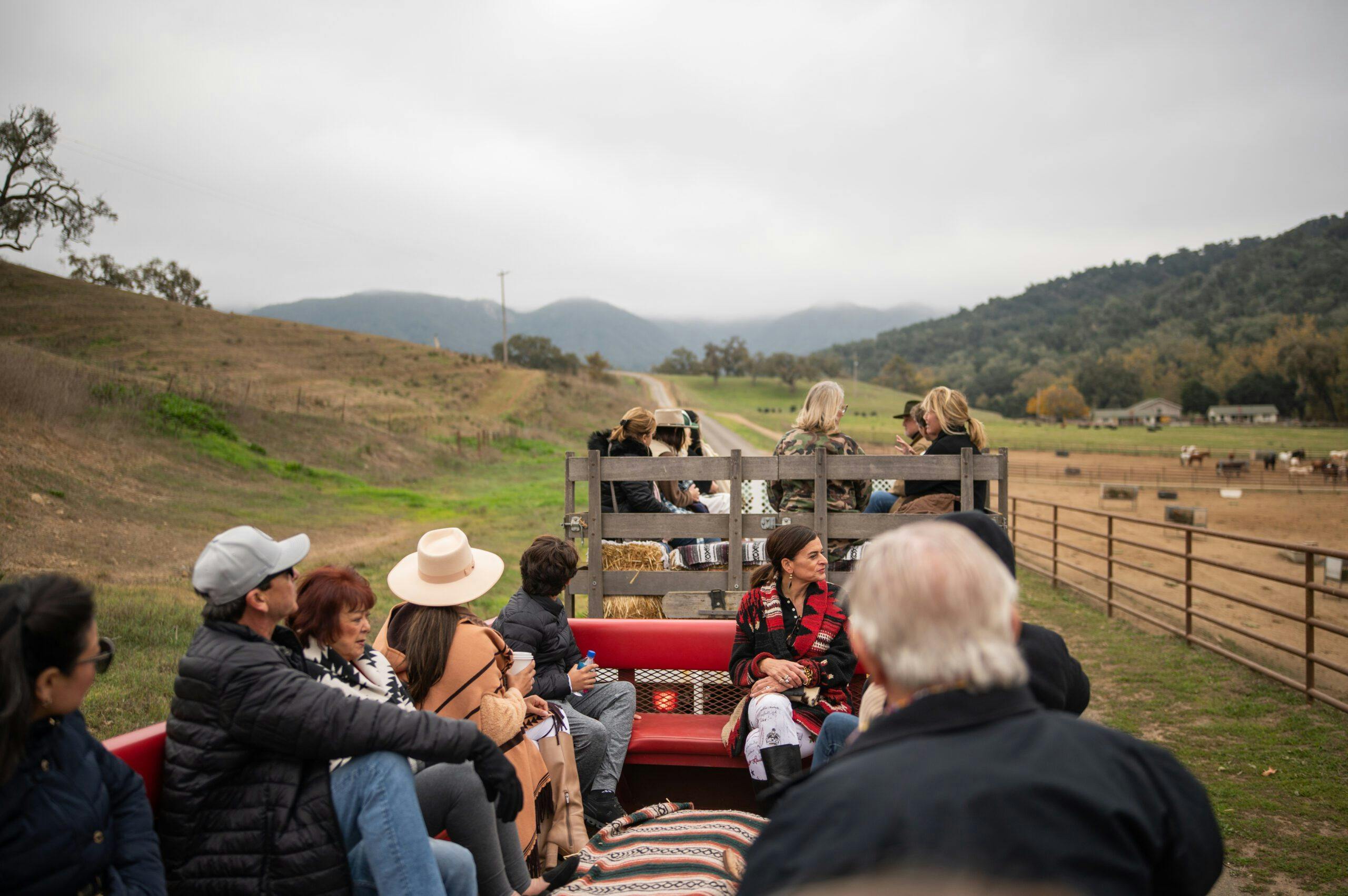 group of people on a wagon ride along the ranch