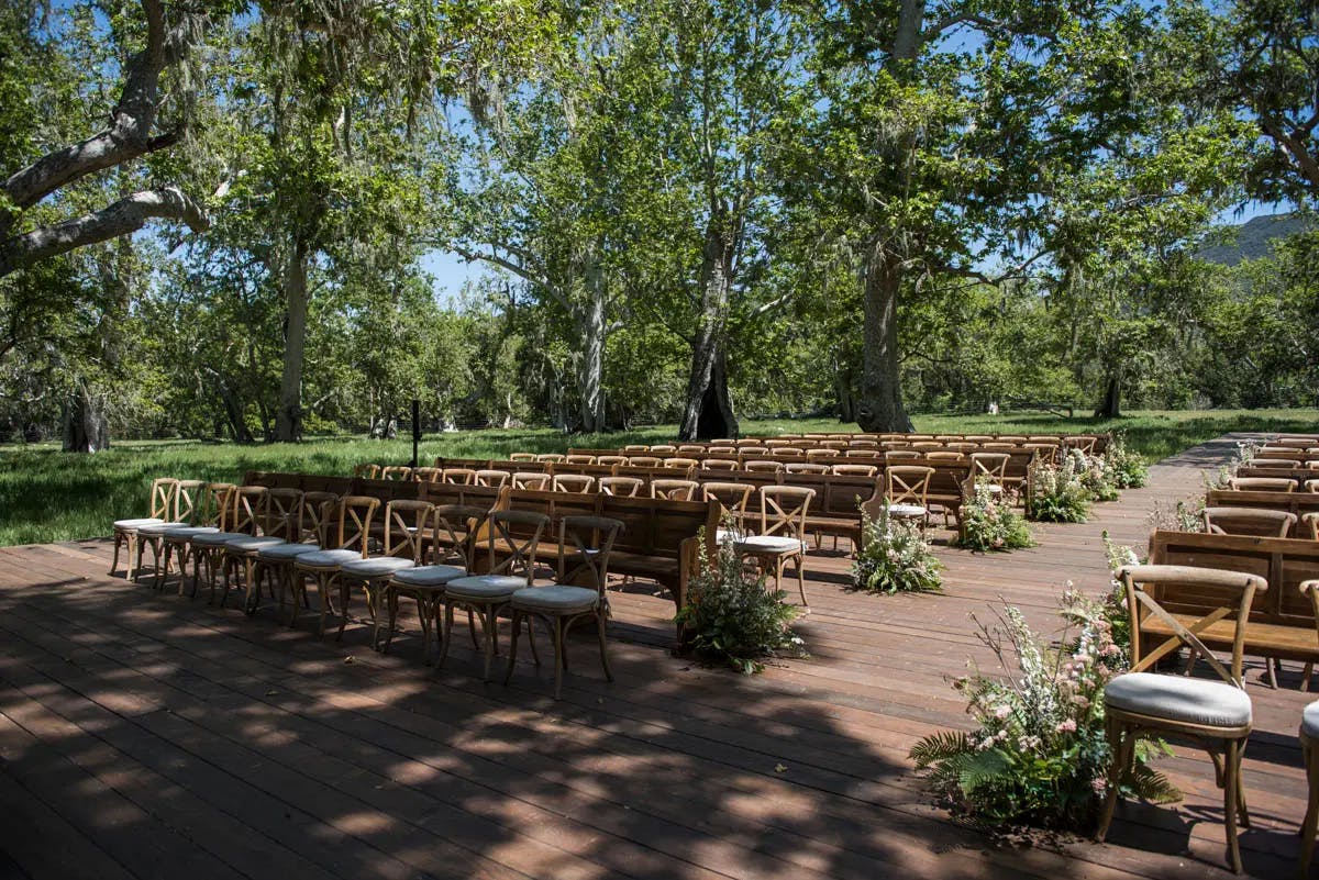 Chairs lined up for wedding ceremony in the sycamore grove at Alisal